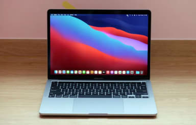 A macbook pro on a wooden table